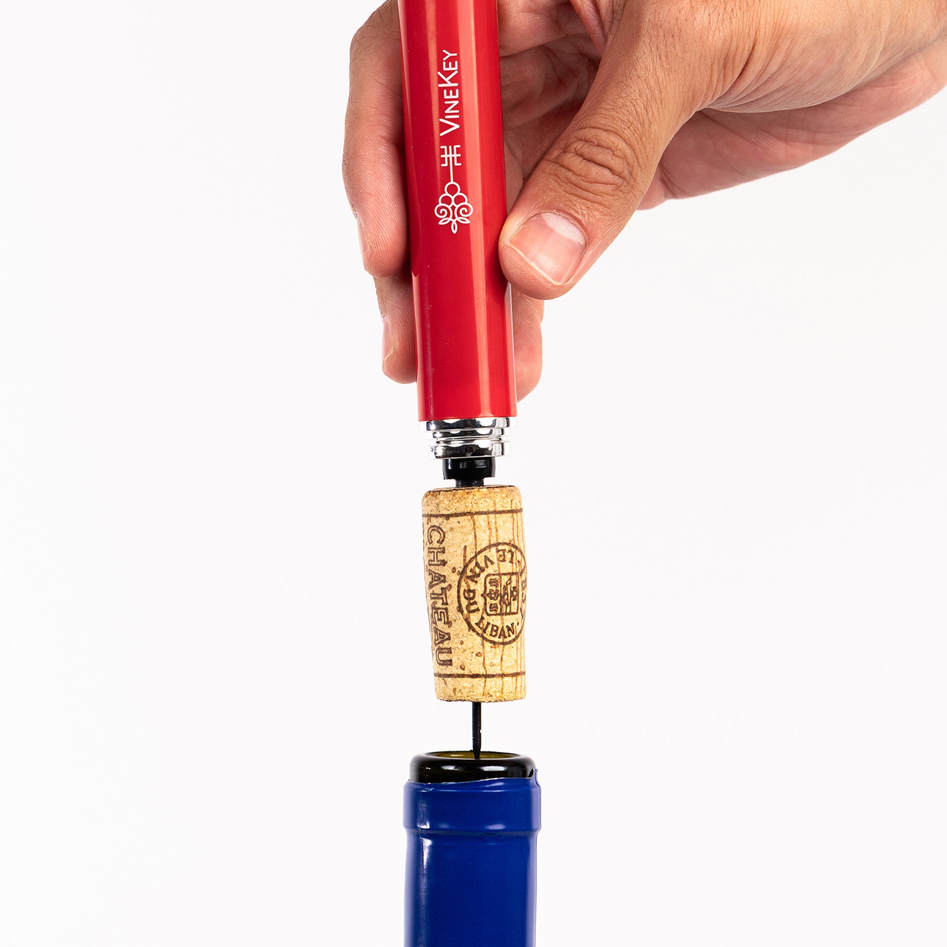 VineKey red wine opener pen being inserted into the cork with air pressure
