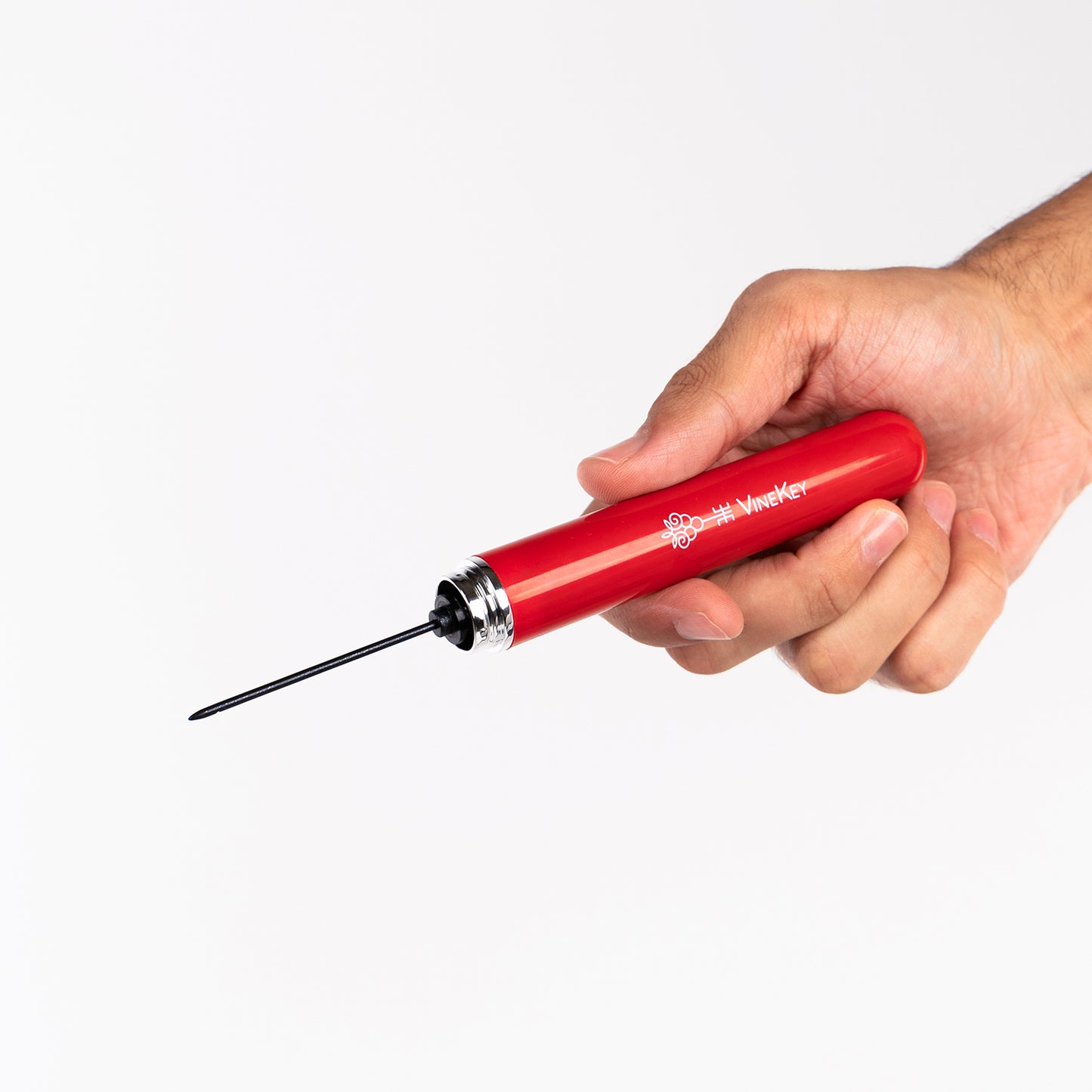 Close-up of the VineKey red opener pen showing the exposed needle